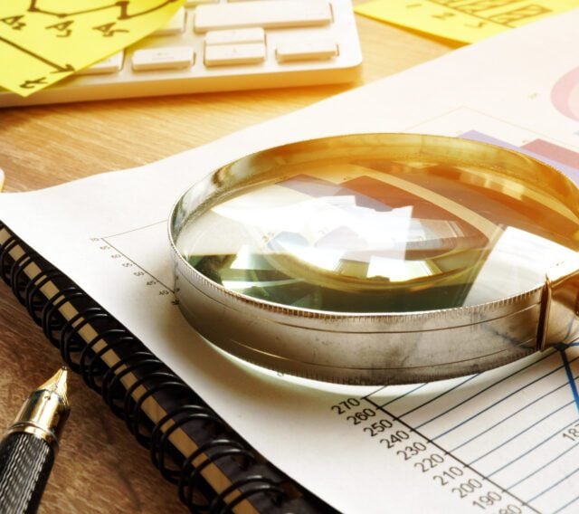 magnifying glass on analytics report